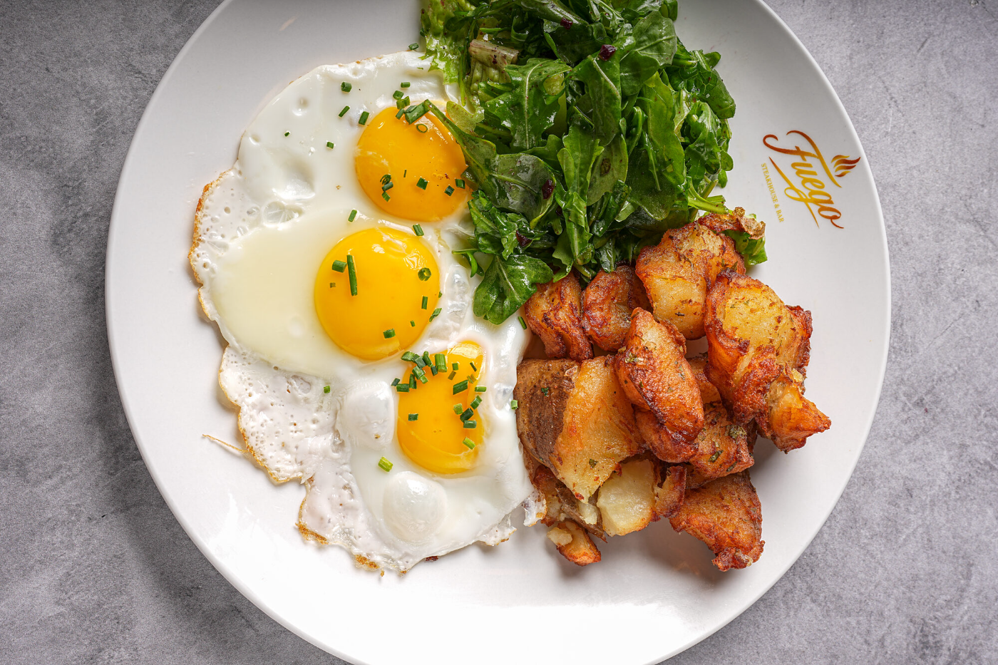 Sunny-side eggs with crispy bacon and home potatoes