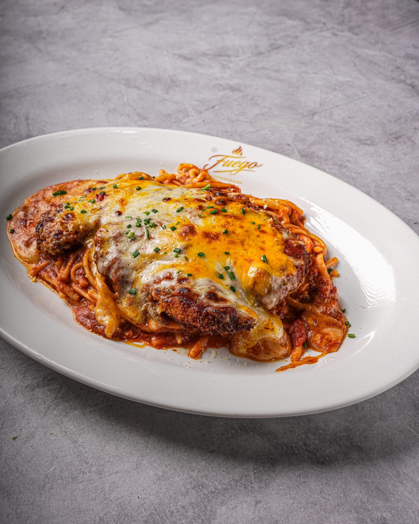 Baked chicken parmesan bubbling with melted cheese