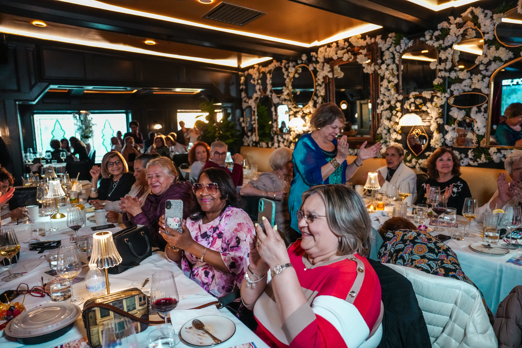 A full dining room of guests celebrating together at Fuego Steakhouse & Bar